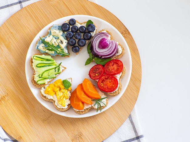 Rainbow sandwiches heart shape on white table