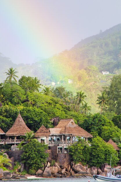 Rainbow over tropical island and luxurious hotel