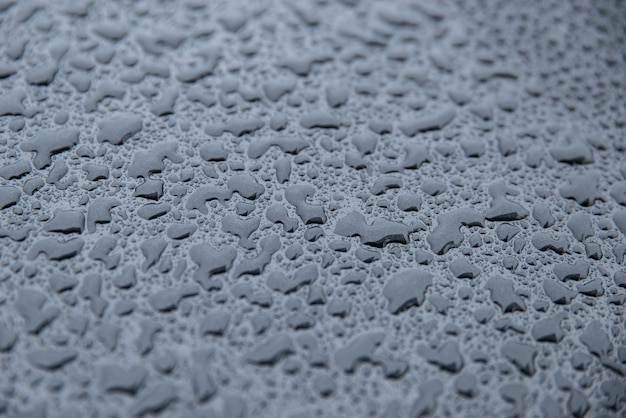 Raindrops on a black background. Texture of drops. Anti-rain for cars