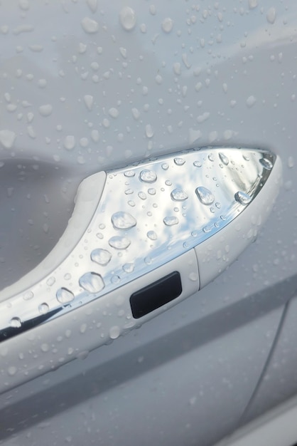 Raindrops on a car door handle