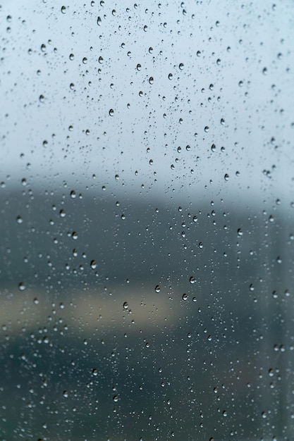 Raindrops on a window on a rainy day rain concept textures and patterns