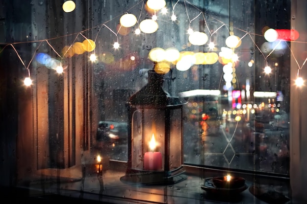 Rainy evening city view,car traffic light, from window people walk , candle light reflection rain