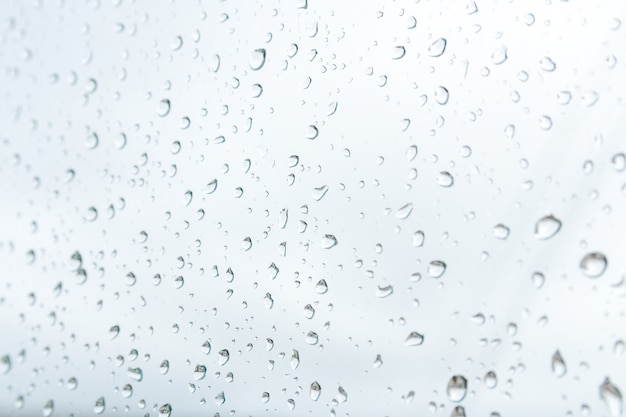 Rainy weather forecast. close up raindrops on the window just before heavy rain and storm.