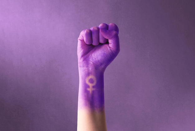 Raised purple fist of a woman for international women39s day and the feminist movement March 8 for feminism independence freedom empowerment and activism for women rights