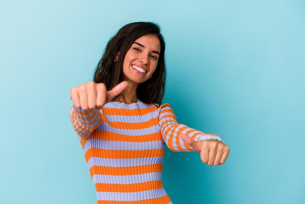 Raising both thumbs up smiling and confident