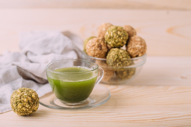 Raisins almond honey bliss balls. Healthy Oatmeal Snacks Energy Balls with Oats Almond Butter and Honey. Cup of matcha tea