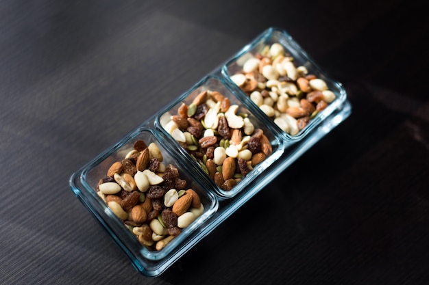 Raisins, peanuts and pistachio in elegant glass bowls