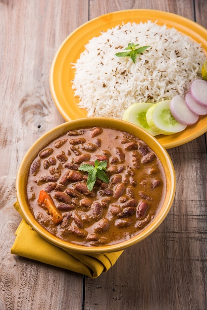 Rajma Or Razma is a popular North Indian Food, consisting of cooked red kidney beans in a thick gravy with spices. Served in bowl with Jeera Rice &amp; green salad