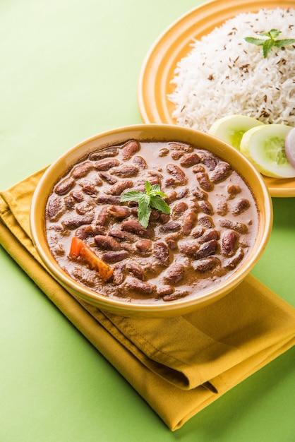 Rajma Or Razma is a popular North Indian Food, consisting of cooked red kidney beans in a thick gravy with spices. Served in bowl with Jeera Rice &amp; green salad