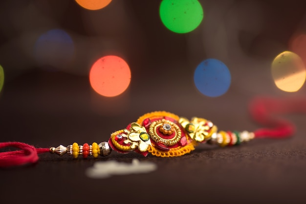 Raksha Bandhan background with an elegant Rakhi.