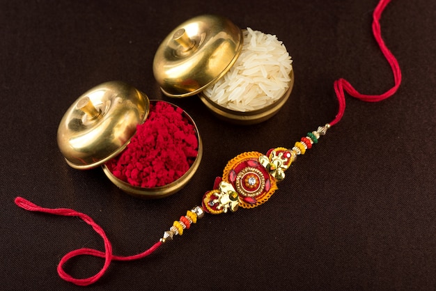 Raksha Bandhan with an elegant Rakhi, Rice Grains and Kumkum. A traditional Indian wrist band which is a symbol of love between Brothers and Sisters.