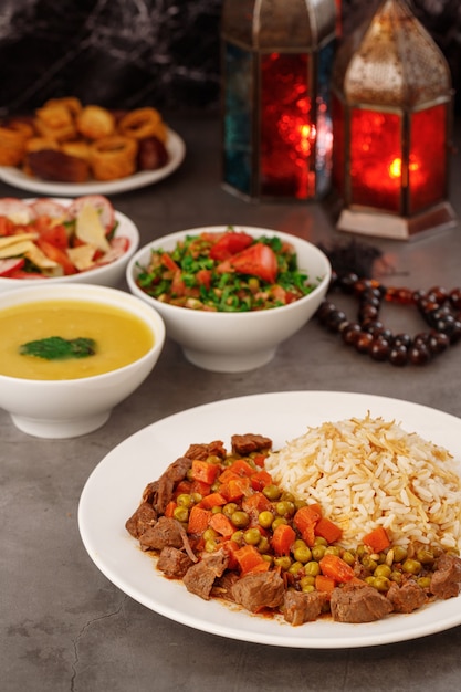 Ramadan Arabic family dinner Traditional arabic food Closeup view Eid Mubarak Table with sharing plates food Ramadan decoration Lebanese cuisine Starters hummus baklava dates Muslim people