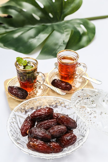 Ramadan inspiration showing date palms in a crystal bowl with cups of tea