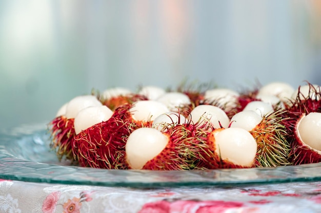 Rambutan bark is cut in half on glass dish and ready to eat