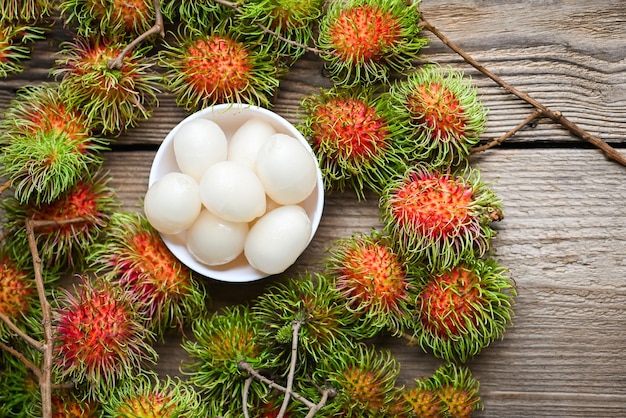 Rambutan fruit harvest from the garden rambutan tree Fresh and ripe rambutan sweet tropical fruit peeled rambutan