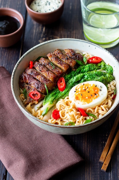 Ramen soup with duck noodles cabbage pepper and egg Asian food