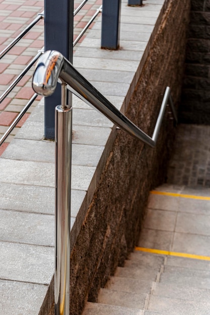 A ramp and metal railings at the entrance to the residential building for the convenience of disabled and elderly people.