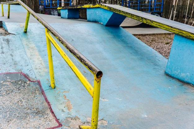 A ramp with an iron ramp for jumping in a skate park