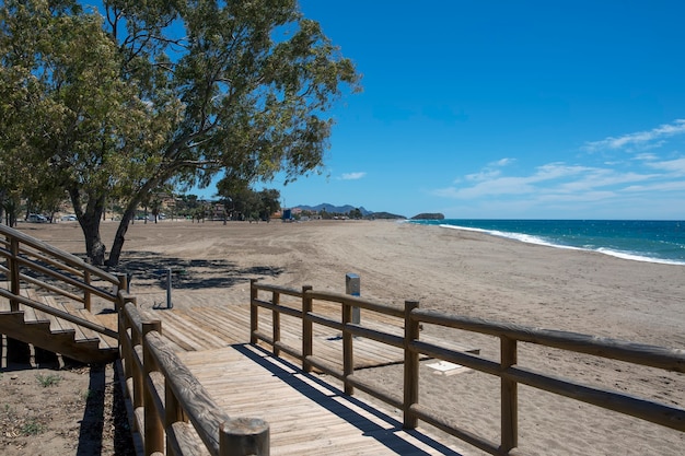 Ramp with a wooden railing which goes down to the lonely beach of Bolnuevo Mazarron Murcia Spain