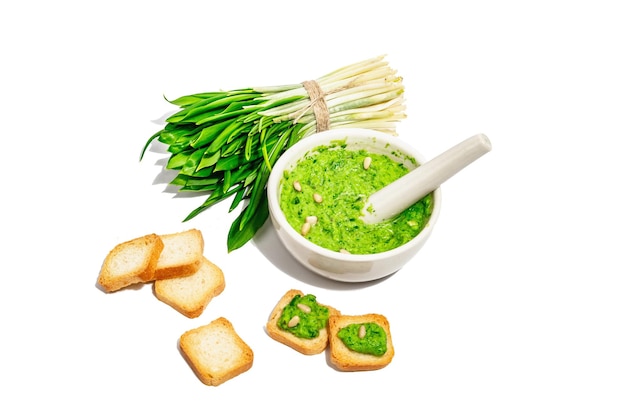 Ramson pesto with olive oil parmesan and pine nuts isolated on white background