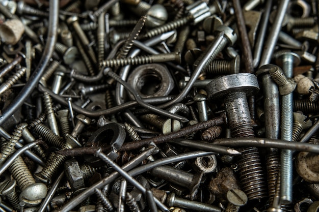 Range Rusty old screws bolts nuts. Grunge metal Hardware details dark