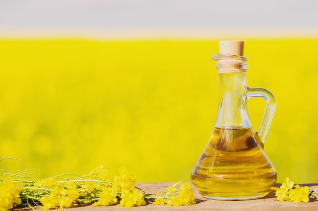 Rapeseed oil (canola) on background field and sky