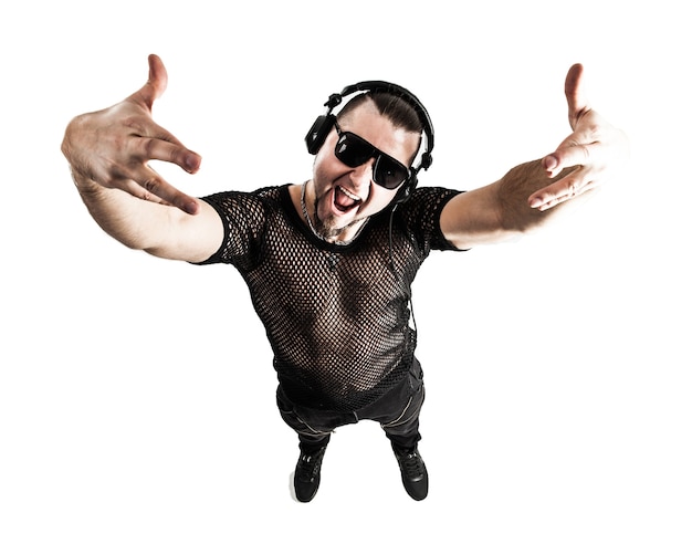 rapper in a stylish t-shirt with headphones and with hands up on white