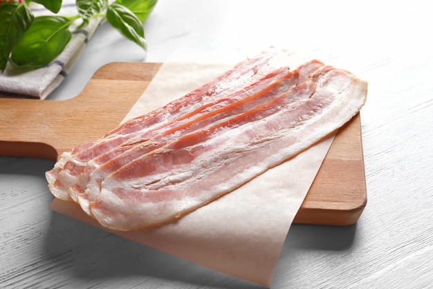 Rashers of bacon on wooden board