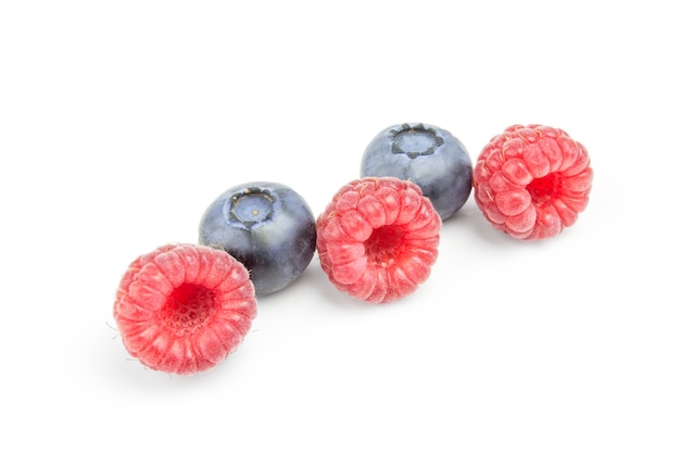 Raspberries and blueberries in row isolated