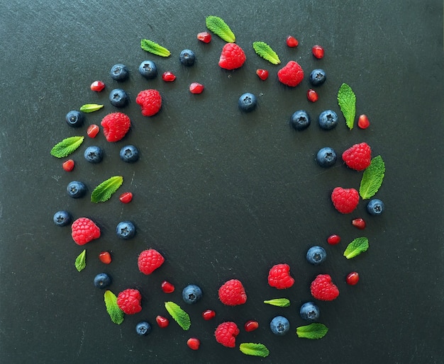 raspberries mint leaves blueberries and pomegranate seeds