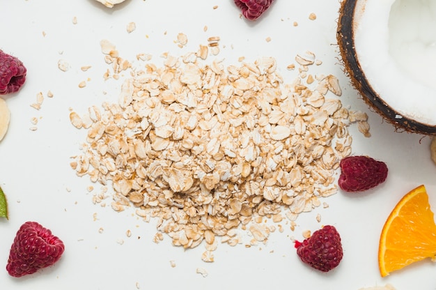 Raspberry; coconut and oats against white background