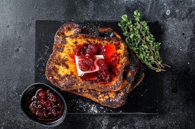 Raspberry French Toast with butter on marble board Black background Top view