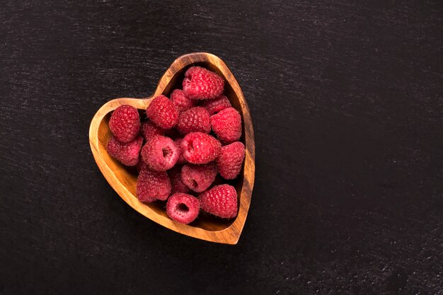 Raspberry in heart shaped wooden bowls