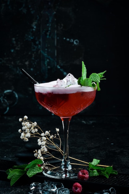 Raspberry margarita Cocktail with raspberry liqueur in a glass Bar menu On a black background