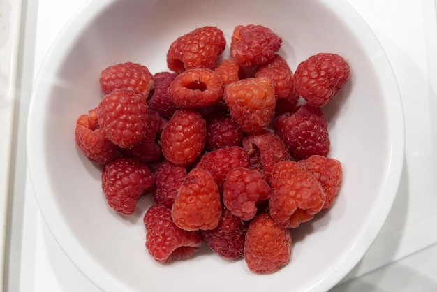 Raspberry on plate isolated on white background