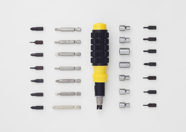 Photo ratchet screwdriver well arranged over white background above view