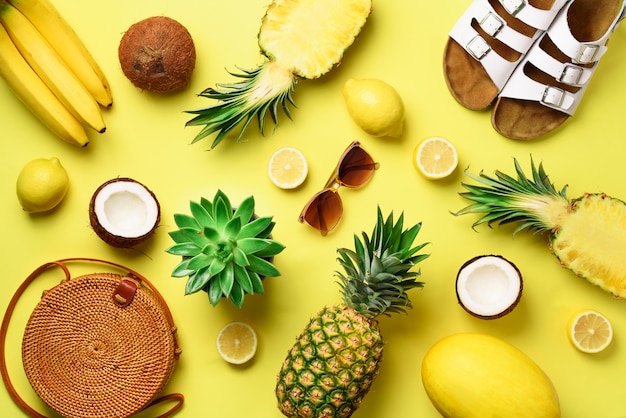 Rattan bag, shoes and yellow fruits on sunny background