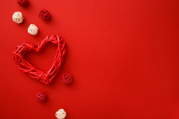 Rattan hearts with decoration on red  flat lay. Valentines Day celebration .