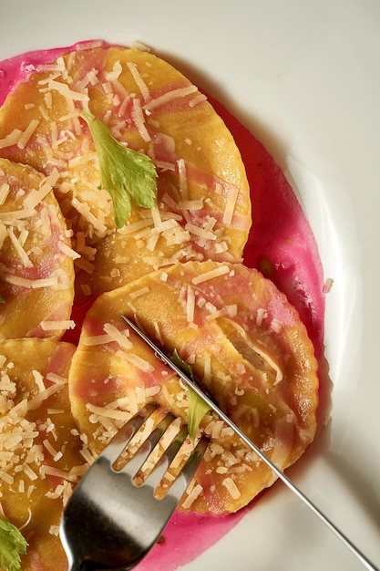 Ravioli with stuffing in pink sauce Closeup Selective focus Noise in postproduction