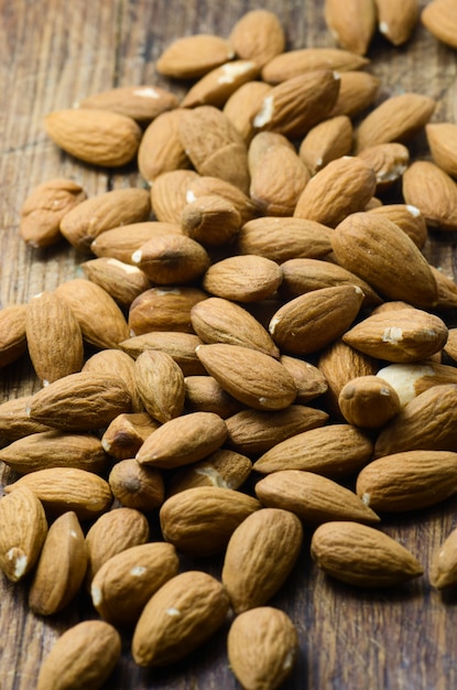 Raw almond on wooden board