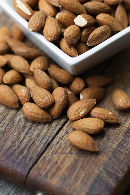 Raw almond on wooden board