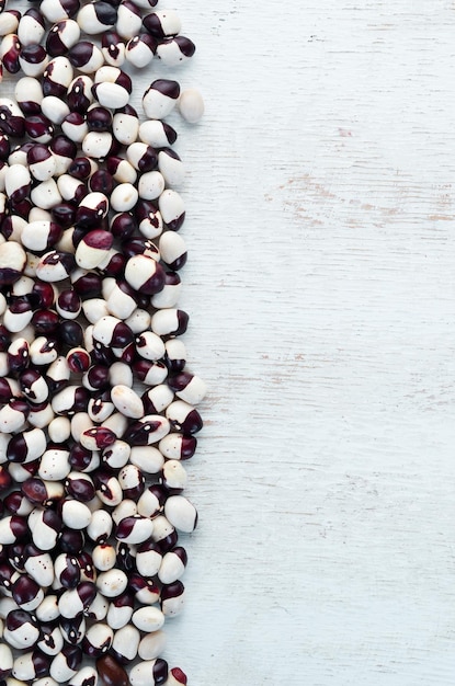 Raw beans on a white wooden background Top view Free copy space