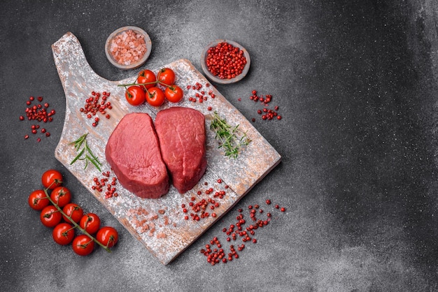 Raw beef eye steak round with salt spices and herbs