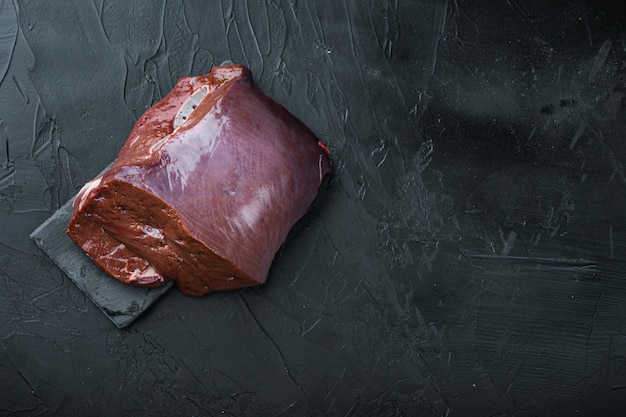 Raw beef liver on wooden board