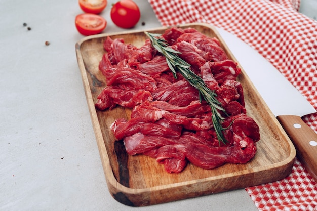 Raw beef meat fillet on wooden board close up