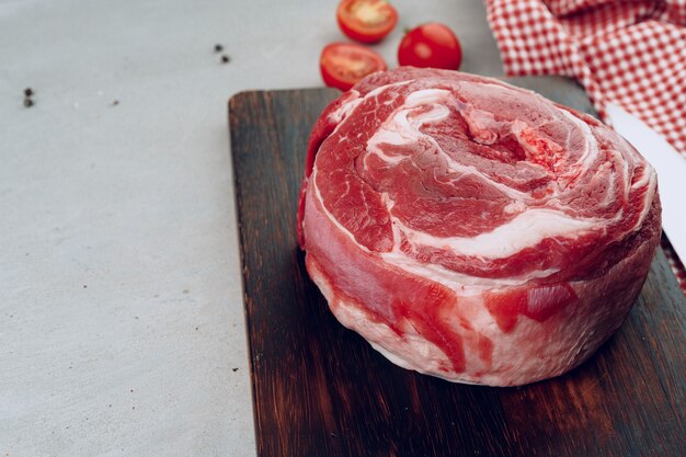 Raw beef meat fillet on wooden board close up