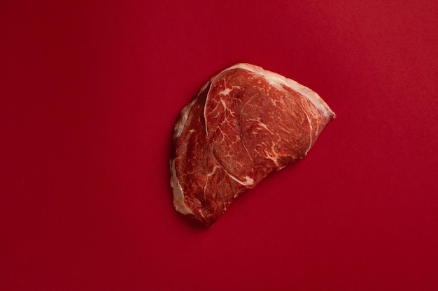 Raw beef meat steak isolated on a blood background