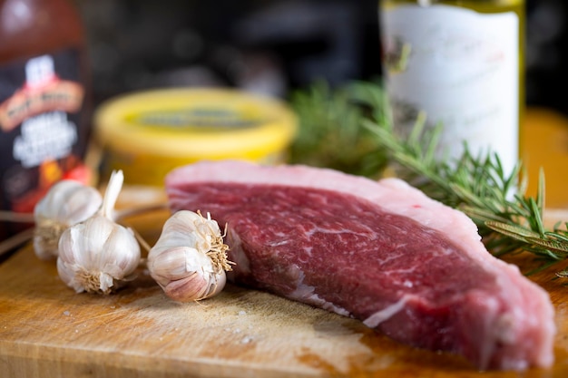 Raw beef slice on cutting board, kitchen background.