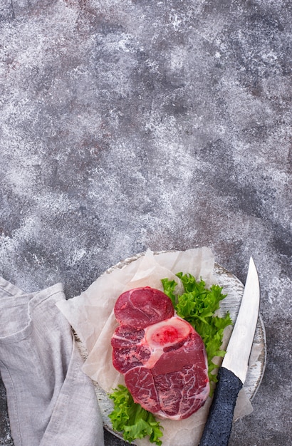 Raw beef steak ossobuco on cutting board