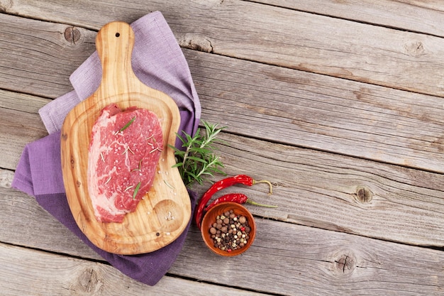 Raw beef steak with spices and herbs